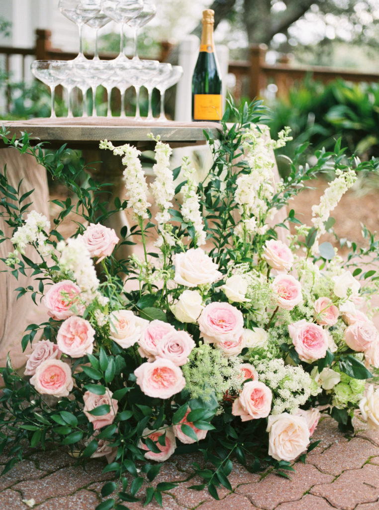 Flowers wrapping a champagne tower